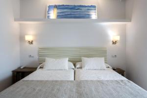 拉萨维纳巴伊亚酒店的一间卧室配有一张带两个白色枕头的床