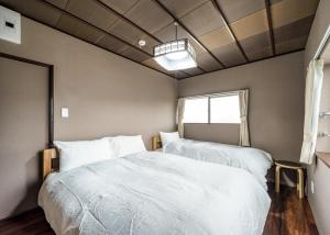 金泽Kanazawa - Apartment / Vacation STAY 80425的一间卧室设有两张床和窗户。