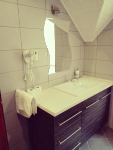 NagypáliFőnix Apartmanház的一间带水槽和镜子的浴室