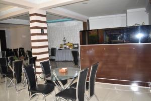 科恰班巴Hotel Briston的一间设有玻璃桌和椅子的用餐室