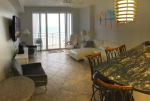 代托纳海滩Ocean Walk Resort 603的客厅配有桌子和沙发