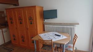 圣瓦伦蒂诺阿拉穆塔Pension Tirol的一间带桌子和橱柜的厨房以及一台电视