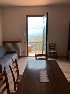 蒙泰斯佩尔托利Appartamento con vista sulle colline Toscane的客厅设有桌子和大窗户