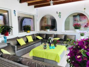 卡武埃鲁Villa Sunkiss Algarve Carvoeiro的天井配有沙发、桌子和鲜花