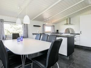 瓦伊厄斯斯特兰德8 person holiday home in Vejers Strand的厨房以及带桌椅的用餐室。
