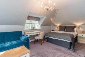 沃金Gorse Hill Hotel的一间卧室配有一张床、一张沙发和一把椅子