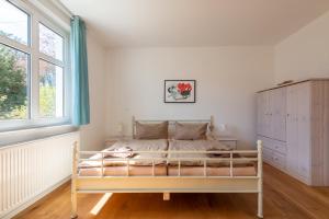 格拉尔-米里茨Ferienwohnung HIMBEERE mit großem Garten的卧室配有白色的床和窗户。
