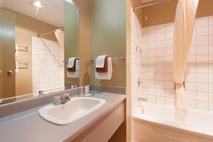 弗尼弗尼坡旅舍的浴室配有盥洗盆、镜子和浴缸