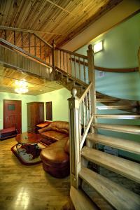 斯基希德尼萨Едем的客厅位于房子内,设有螺旋楼梯