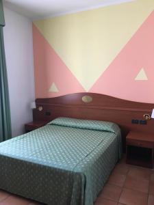 博洛尼亚可特露娜酒店的一间卧室配有一张床和条纹墙