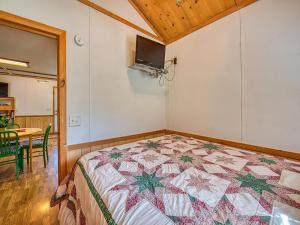 马吉谷Maggie Valley Cabin Rentals的一间卧室配有床,床上装有被子
