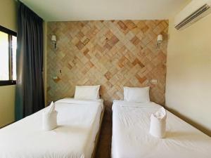 旺普拉别墅度假村客房内的一张或多张床位
