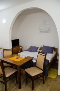 索科矿泉村Apartments Ozren的卧室配有一张床和一张桌子及椅子