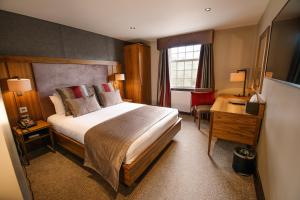 巴斯比巴斯比酒店的酒店客房设有一张大床和一张书桌。