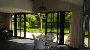 HuppayeLa Miellerie的客厅配有桌椅和滑动玻璃门