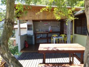弗洛里亚诺波利斯Magic Island Casas的木甲板配有桌子和厨房