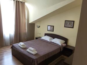 金沙Guest Rooms Flirt的一间卧室配有一张床,上面有两条毛巾