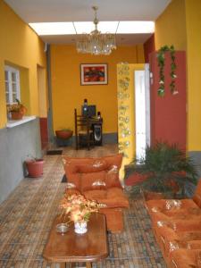 拉巴斯伊斯多罗斯酒店的客厅配有橙色沙发和桌子