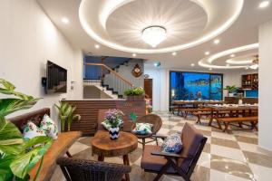 会安Seaweed Luxury Villa & Spa的一间带桌椅和大型天花板的餐厅