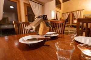 圣费朗索瓦-隆尚Parc Madeleine - APARTMENTS的一张木桌,上面有刀子和盘子