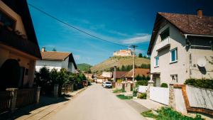 Krásnohorské PodhradieCastle Village Apartment的山丘上一座城堡村庄的街道