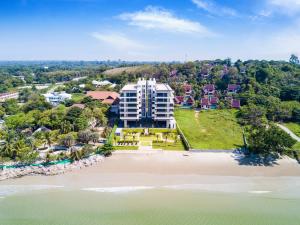 罗勇Escape Condominiums Beachfront Suites - Mae Phim的从海滩上欣赏到度假村的空中景色