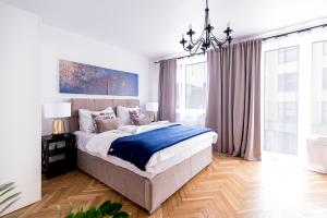 弗罗茨瓦夫Apartament Oławska的一间卧室配有一张大床和一个吊灯。
