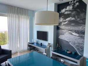 米兹多洛杰Apartament 37 Playa Baltis przy plaży的客厅配有玻璃桌和电视