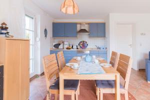 欧巴德伍斯图Haus SWANTE WUSTROW的厨房配有木桌和蓝色橱柜。