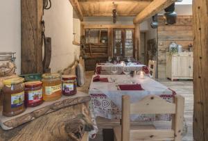 瓦尔迪登特罗Agriturismo Baita De L'ALL的一间用餐室,配有一张带蜂蜜罐的桌子