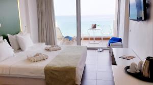 卡法斯Erytha Hotel & Resort Chios的酒店客房设有一张床和一个大窗户