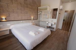 LorcaCasa Nahia Hostal Rural的卧室配有白色大床和水槽