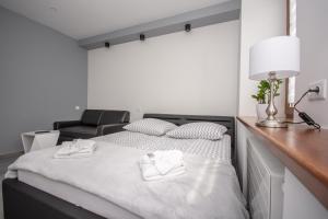 琴斯托霍瓦Apartamenty AP 11的一间卧室配有一张带两条白色毛巾的床