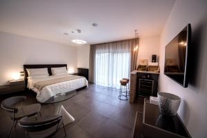 GenazzanoAminta Resort的卧室配有一张床和一张桌子及椅子