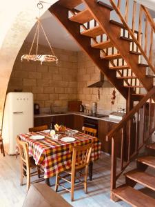 VouniVouni Clock House的厨房以及带桌子和楼梯的用餐室。