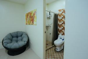MabalacatOYO 645 Ljenj Apartelle的一间带蓝色椅子和卫生间的浴室