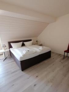 阿恩斯贝格Hotel zur Post的铺有木地板的客房内一张大床