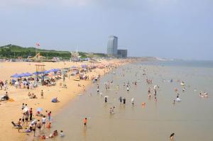 Laizhou7天优品·莱州市政府店的海滩上一群人