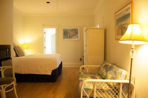 基韦斯特Duval House的酒店客房配有床、沙发和灯具。