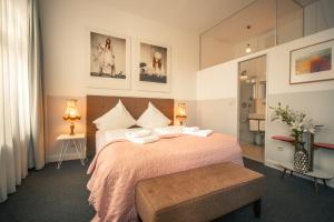 科隆MAISON MARSIL - Boutique Hotel Köln的一间卧室配有一张带粉色毯子的大床