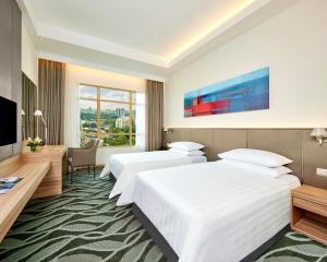 吉隆坡Sunway Lagoon Hotel , formerly Sunway Clio Hotel的酒店客房设有两张床和电视。
