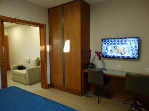坎皮纳斯Casa do Professor Visitante Unicamp的酒店客房配有一张床、一张桌子和一把椅子。