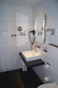 圣马丁圣玛蒂拿卡斯特尔酒店的白色的浴室设有水槽和镜子