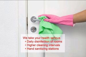因特拉肯河流假日公寓的粉色手套的人用毛巾擦门