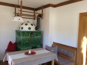 萨菲登安斯泰内嫩米尔恩特尔布劳尔法姆斯里德尔酒店的一间带桌子和绿色炉灶的用餐室