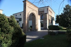 Cazzago San Martino欧雷布中心圣玛丽亚德尔阿尔科度假屋的一座大砖砌建筑,在院子里设有拱门