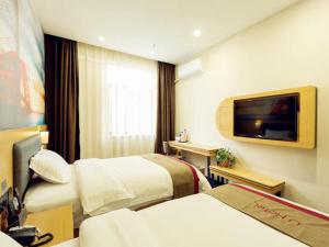 西安尚客优酒店陕西西安未央区高铁北客站店的酒店客房设有两张床和一台平面电视。