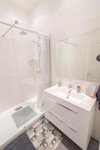 尼斯玛伊奥翁宾馆的白色的浴室设有水槽和淋浴。