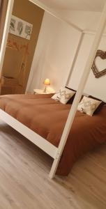 Bordeaux-Saint-ClairLe cosy de sarah的一间卧室设有一张大床,铺有木地板