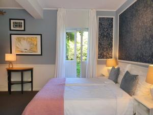 KlimmenBoutique Hotel Villa de Proosdij的一间卧室设有一张大床和一个窗户。